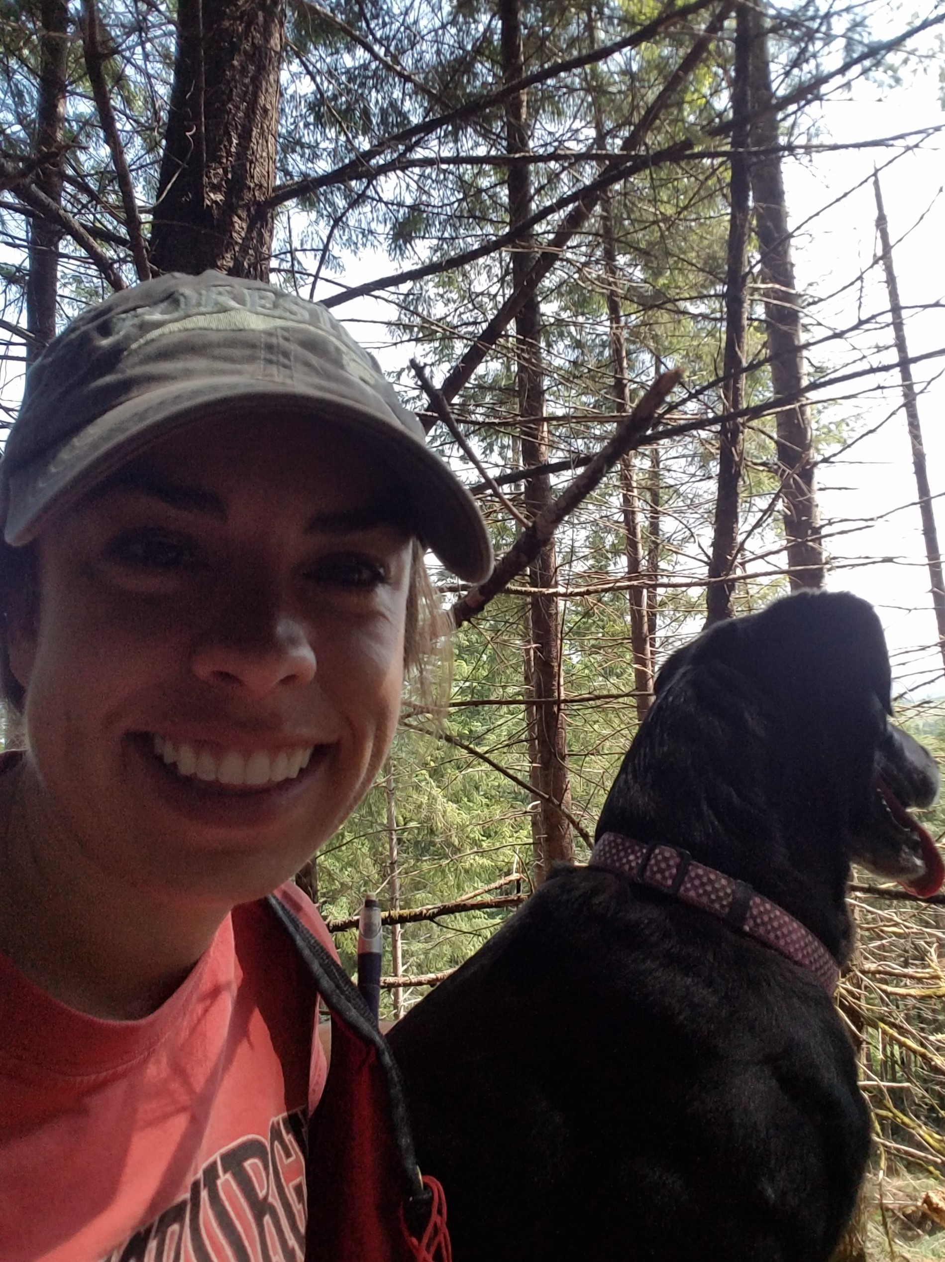 Whitney in the forest with her dog. 
