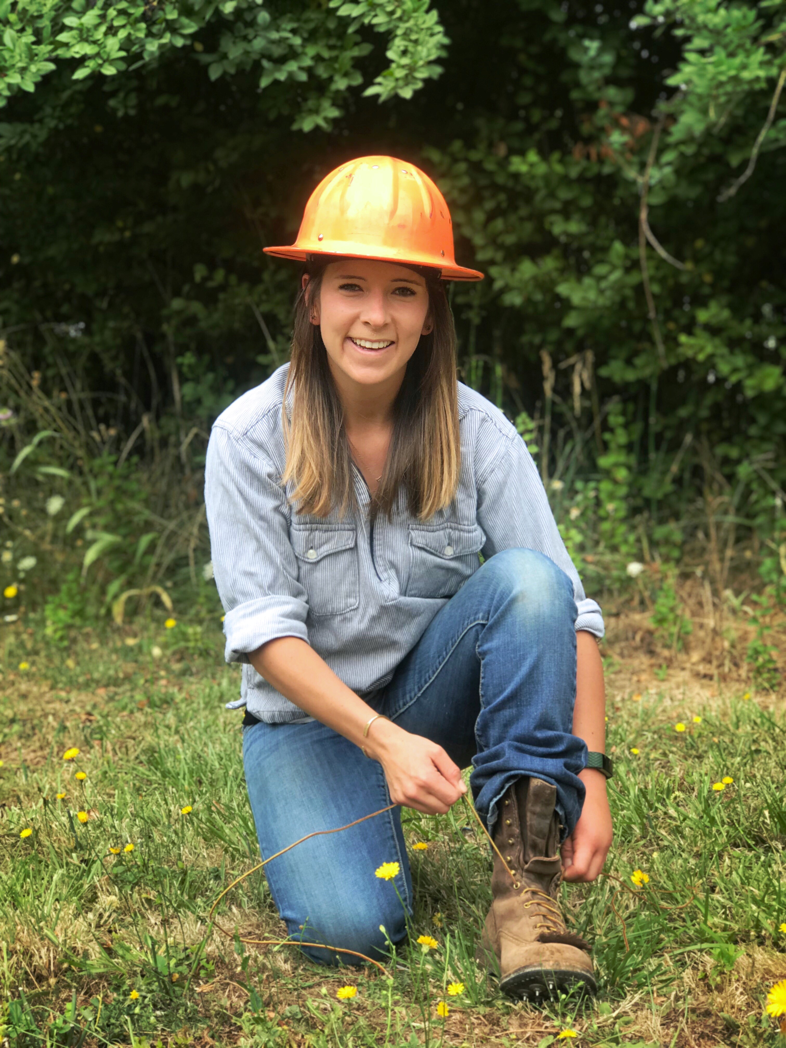 Anna on one knee tying her shoe.