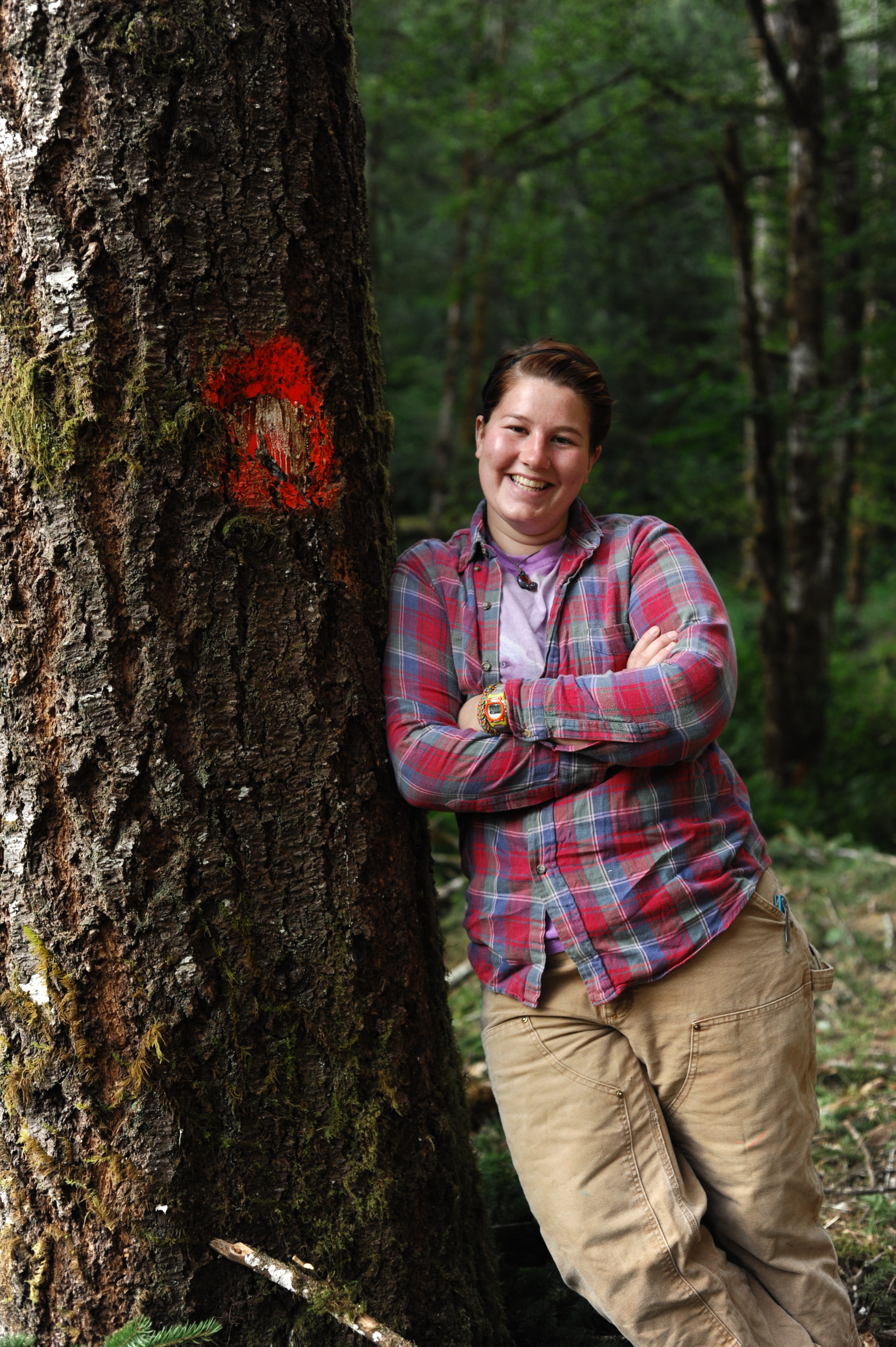 Katie leaning up against a big tree. 
