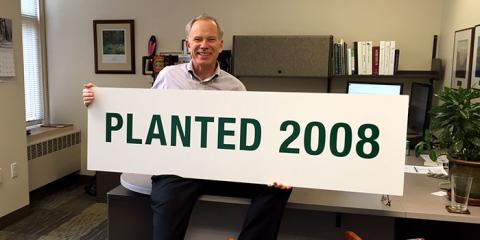 Paul Barnum holds a planted sign