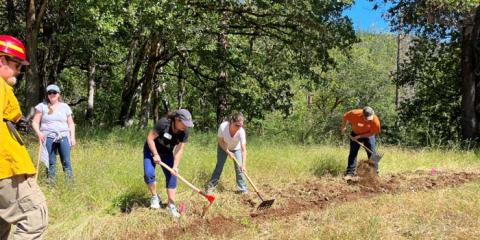 Teacher workshop participants digging fire line