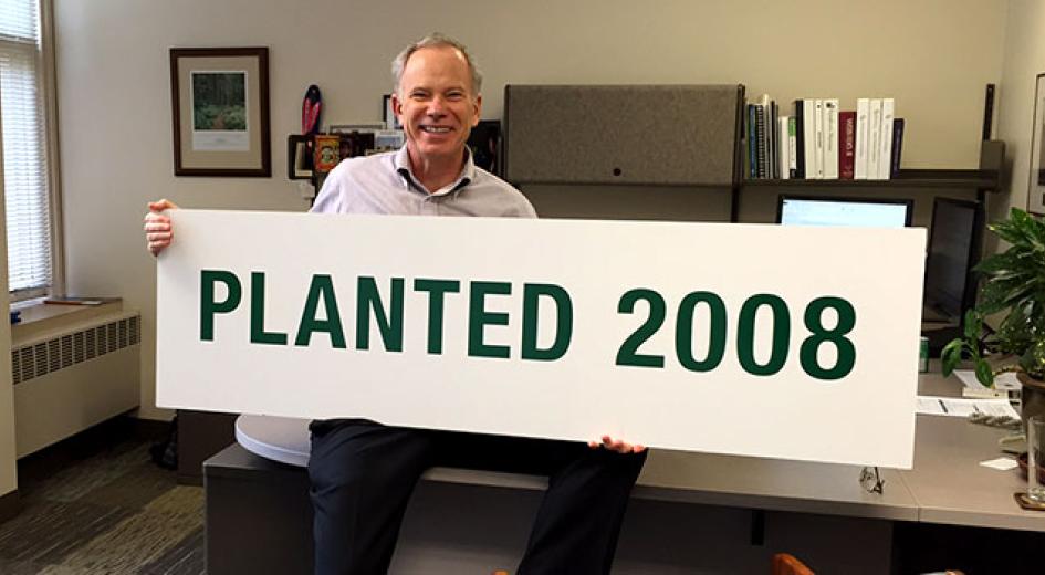 Paul Barnum holds a planted sign
